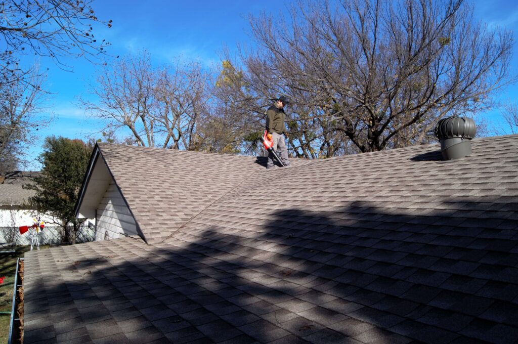 Best roof cleaning services in Denton TX removing black roof stains using soft wash method on residential shingles